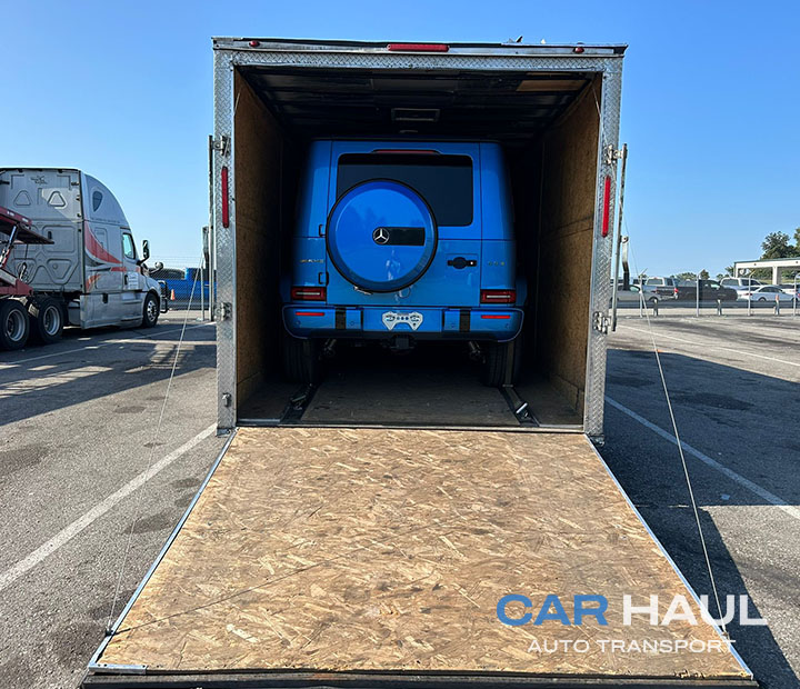 Blue Mercedes-Benz G-Class loaded inside a trailer